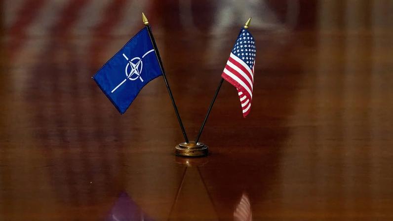 NATO and U.S. flags are set on the table as U.S. Defense Secretary Pete Hegseth and NATO Secretary General Mark Rutte meet at the Pentagon in Washington, D.C., U.S., April 24, 2025. REUTERS/Nathan Howard