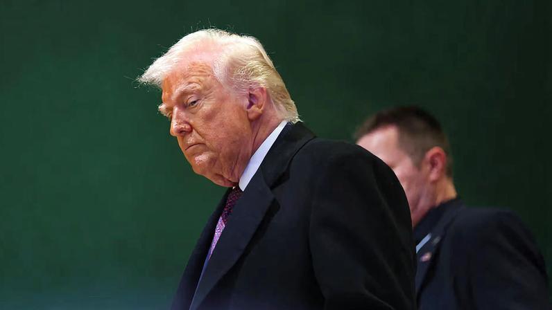 U.S. President Donald Trump walks during the 56th annual World Economic Forum (WEF) meeting in Davos, Switzerland, January 22, 2026. REUTERS/Denis Balibouse