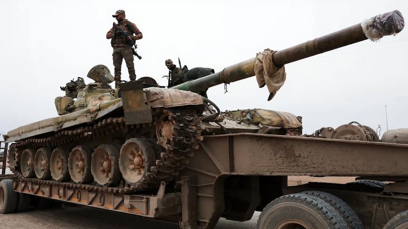 A member of the Syrian army stands over a tank, following the withdrawal of Kurdish-led Syrian Democratic Forces (SDF), in Maskanah, near Aleppo, Syria, January 17, 2026. REUTERS/Mahmoud Hassano