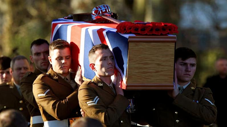 Soldiers from the Royal Regiment of Scotland carry the coffin of Captain Walter Barrie after his funeral service at Glencorse Kirk near Edinburgh, Scotland