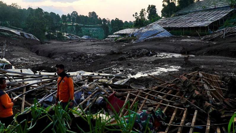 Indonesian rescue members stand near damaged houses after a landslide hit Pasirlangu village, West Bandung, West Java province, Indonesia, January 24, 2026. REUTERS/Yusep Maulana