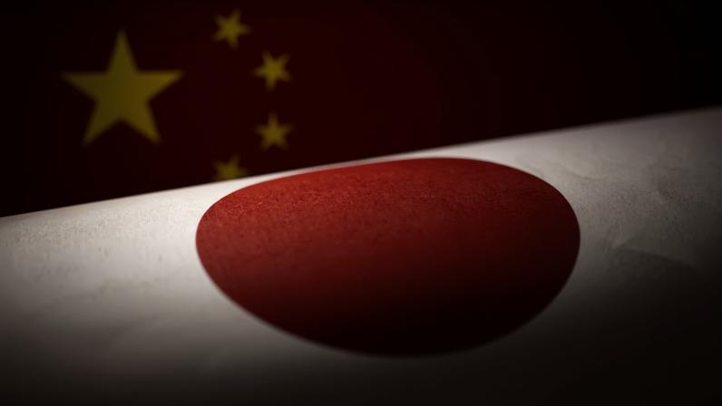 Printed Chinese and Japanese flags are seen in this illustration, July 21, 2022. REUTERS/Dado Ruvic/Illustration/File Photo