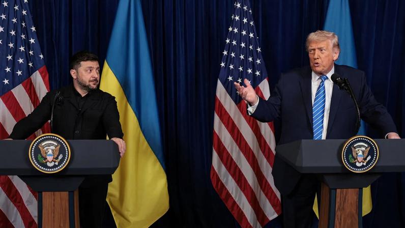 Ukrainian President Volodymyr Zelenskiy listens to U.S. President Donald Trump, after Trump said that Russian President Vladimir Putin expressed willingness to help Ukraine "succeed", during a press conference at Trump's Mar-a-Lago club, in Palm Beach, Florida, U.S., December 28, 2025. REUTERS/Jonathan Ernst