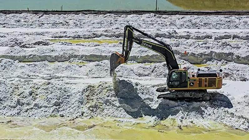 The cover of an FP Collections titled: The Scramble for Critical Minerals with a photo of an excavator atop minerals in a mine.