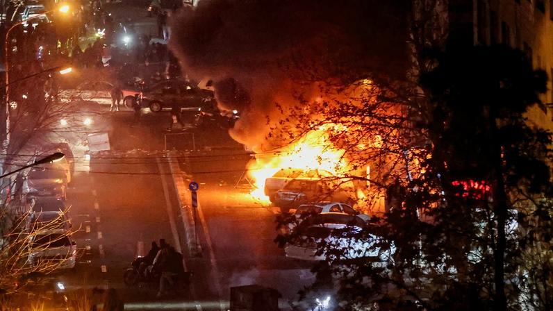 Cars burn in a street during a protest over the collapse of the currency's value, in Tehran, Iran, January 8, 2026. Stringer/WANA (West Asia News Agency) via REUTERS