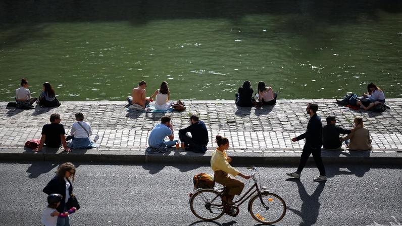 People on the banks of the River Seine in Paris