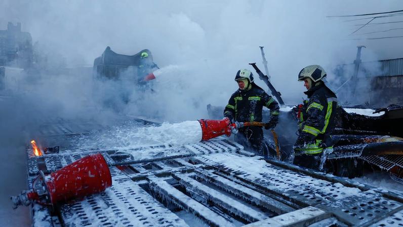 Firefighters extinguish semi-trucks damaged during Russian overnight drone and missile strikes, amid Russia's attack on Ukraine, in Kyiv, Ukraine January 24, 2026.