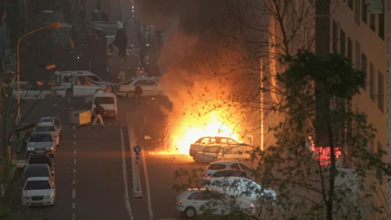 Cars burn in a street during a protest over the collapse of the currency's value, in Tehran, Iran, January 8, 2026. Stringer/WANA (West Asia News Agency) via REUTERS