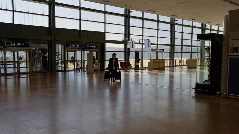 A passenger arrives to a terminal at Ben Gurion International Airport in Lod near Tel Aviv, Israel, January 25, 2021. REUTERS/Ronen Zvulun