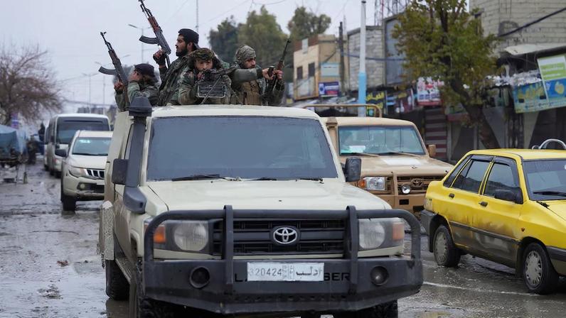 Syrian army military vehicles travel inside the city of Tabqa, after the withdrawal of the Syrian Democratic Forces (SDF)