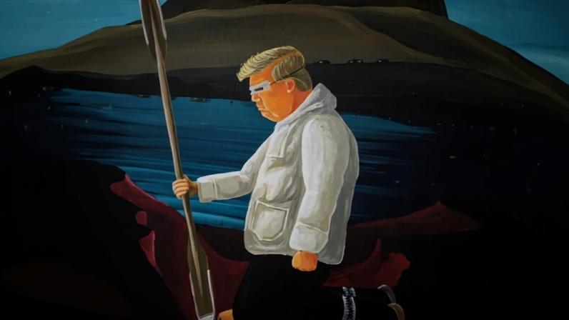 Artwork is displayed in a glass case depicting U.S. President Donald Trump wearing traditional Greenlandic snow goggles and clothing (a white puffy jacket) while digging up minerals with a kayak paddle.