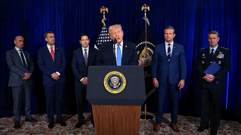 U.S. cabinet members, military leaders, and presidential advisors listen to U.S. President Donald Trump address the media at a podium.