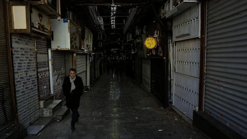 People walk past closed shops following protests over a plunge in the currency's value, in the Tehran Grand Bazaar, Tehran, Iran, December 30, 2025. Majid Asgaripour/WANA (West Asia News Agency) via REUTERS/File Photo