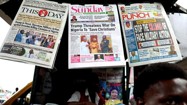 Newspapers with articles reporting U.S. President Donald Trump's message to Nigeria over the treatment of Christians hang at a newspaper stand in Ojuelegba, Lagos, Nigeria November 2, 2025. REUTERS/Sodiq Adelakun/File Photo