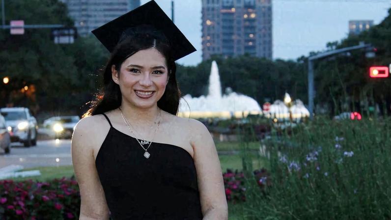 Babson College student Any Lucia Lopez Belloza poses wearing a mortarboard after graduating from high school in Boston