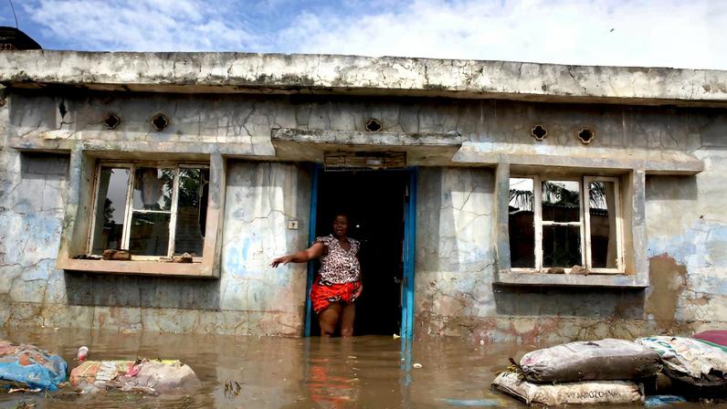 A flood victim stands at her flooded home after weeks of heavy rainfall in Boane District, Maputo, Mozambique, January 19, 2026. REUTERS/Amilton Neves/File Photo
