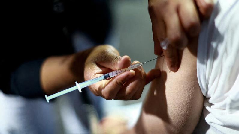 A nurse administers a dose of the measles vaccine to a man during a vaccination campaign in response to a measles outbreak, at the Estadio Olimpico Universitario in Mexico City, Mexico, November 12, 2025. REUTERS/Raquel Cunha/File Photo