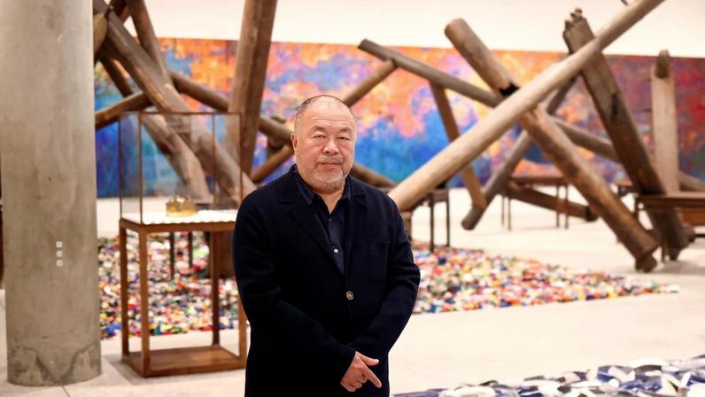 Chinese artist Ai Weiwei poses during a photocall, amongst art pieces displayed in his exhibition "Ai Weiwei: making sense" at the Design Museum in London, Britain, April 4, 2023.