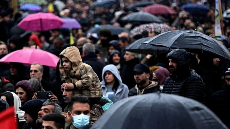 Syrian Kurds attend a protest in solidarity with the people in the neighborhood of Sheikh Maksoud and Ashrafiya, in Qamishli