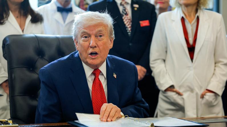 U.S. President Donald Trump sits to sign an executive order recommending loosening the federal regulations on marijuana, in the Oval Office at the White House in Washington