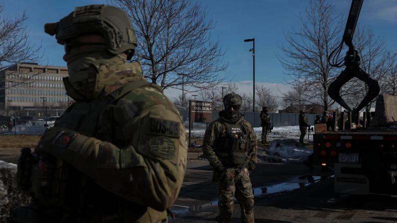 U.S. Immigration and Customs Enforcement (ICE) agents stand guard during protests against increased immigration enforcement and the fatal shooting of Renee Nicole Good by an ICE agent, in Minneapolis, Minnesota, U.S., January 9, 2026. REUTERS/Tyrone Siu