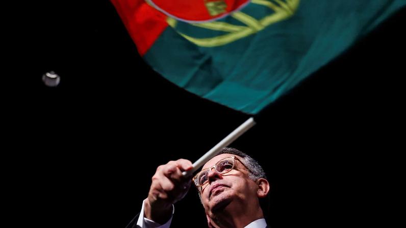 Portuguese presidential candidate of the Socialist Party, Antonio Jose Seguro, holds a Portuguese flag onstage after leading the first round of Portugal's presidential election, in Caldas da Rainha, Portugal, January 19, 2026. REUTERS/Rodrigo Antunes TPX IMAGES OF THE DAY