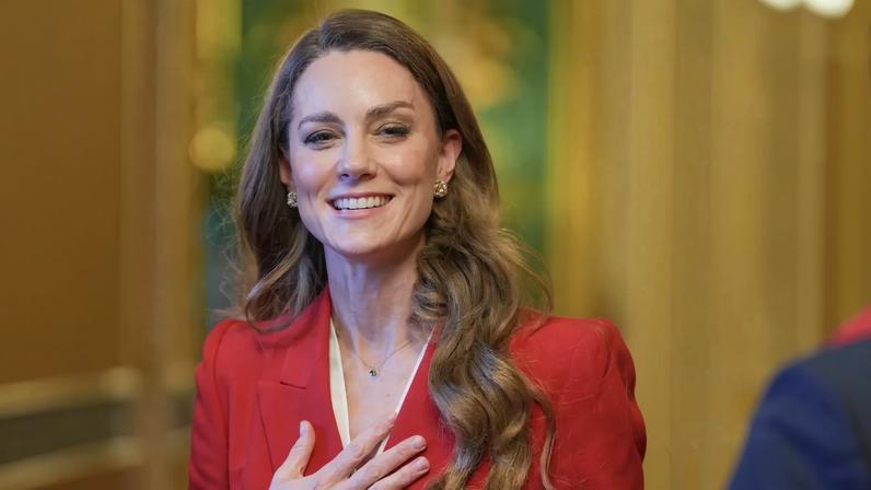 Kate Middleton chose a bright red Alexander McQueen suit for her first solo outing of the year.