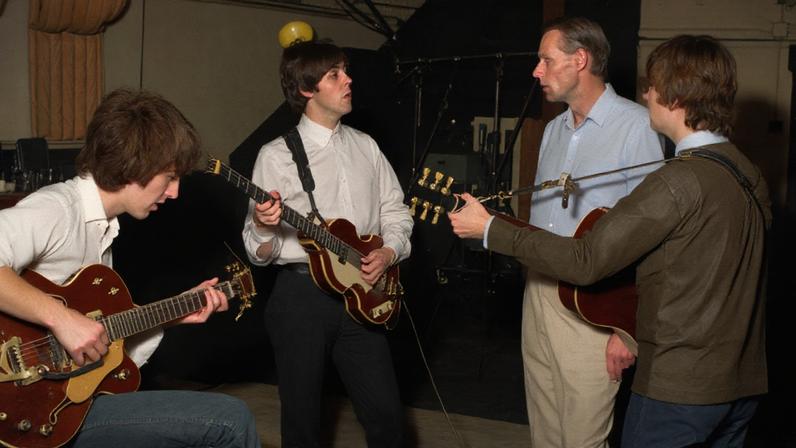 George Martin in the studio with the Beatles, circa 1964.