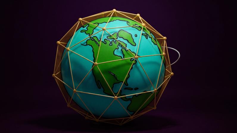 An illustration shows a wireframe protective dome around the earth with a missile acring around it and a missile from the U.S. swooping in to intercept it.