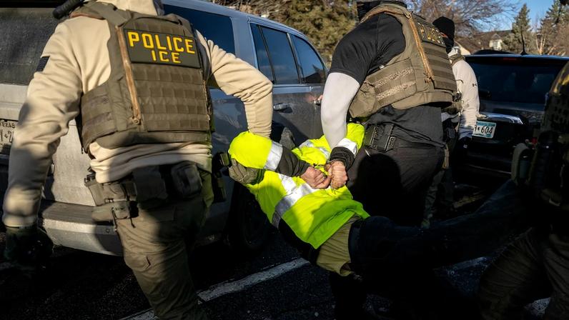 Federal law enforcement agents detain a demonstrator during a raid in south Minneapolis Minnesota US on Tuesday Jan. 13...