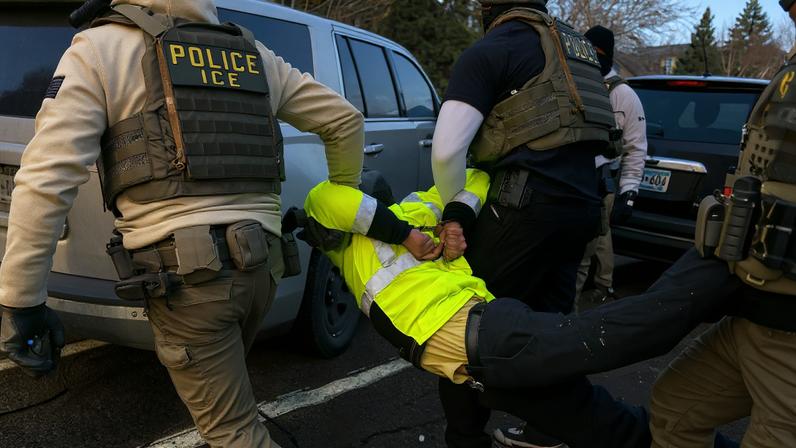 Federal law enforcement agents detain a demonstrator during a raid in south Minneapolis Minnesota US on Tuesday Jan. 13...