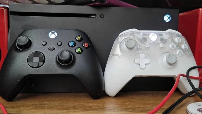 Xbox controllers sit in front of the console.