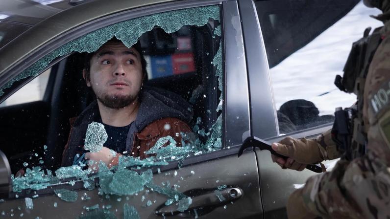 U.S. Border Patrol agents smash a man's car window before dragging him out and taking him into custody when he failed to present citizenship documentation at a gas station on January 11, 2026 in St. Paul, Minnesota.