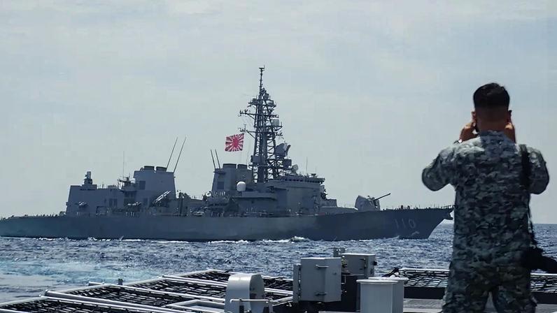 A member of the Philippine Navy looks out at the Japan Maritime Self-Defense Force’s destroyer Takanami during a joint maritime exercise in the South China Sea on June 14, 2025.