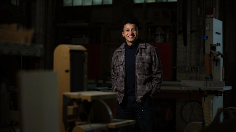 C Jacob Payne poses in an architecture lab space