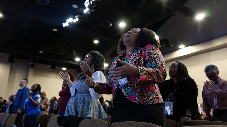 Nehemiah Next Level Up Summit attendees raise their hands in worship to God.