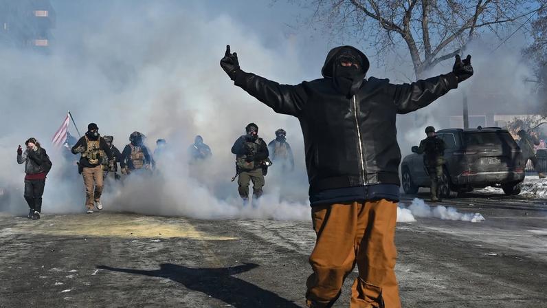 MINNEAPOLIS, MINNESOTA - JANUARY 24: A person taunts federal agents amid protests following a shooting on January 24, 2026 in Minneapolis, Minnesota. Federal agents allegedly shot and killed a protestor amid a scuffle to arrest him. The Trump administration has sent a reported 3,000 federal agents into the area, with more on the way, as they make a push to arrest undocumented immigrants in the region. (Photo by Brandon Bell/Getty Images)