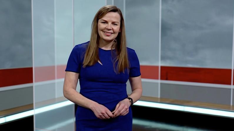Alexis Green in the BBC South Today studio. She is smiling and wearing a blue dress.