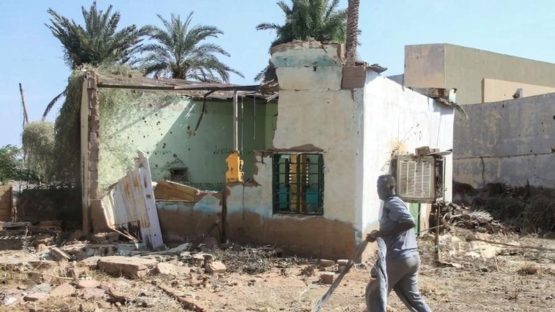 A man walks past a damaged building in Omdurman, Sudan.