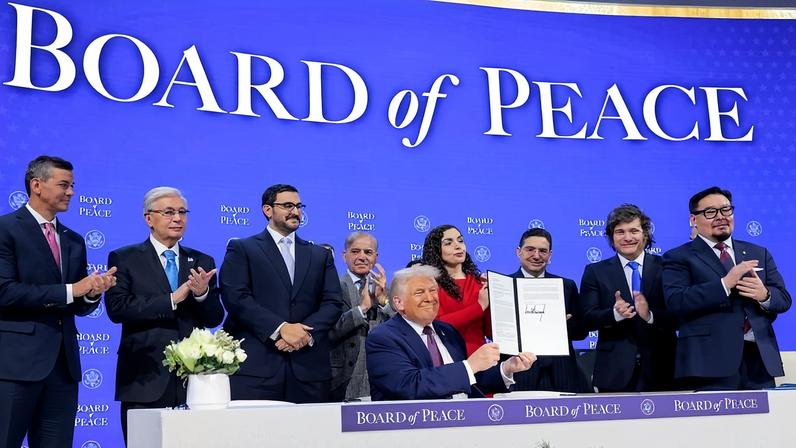 U.S. President Donald Trump (seated) holds up his signature on the founding charter during a signing ceremony for the “Board of Peace” at the World Economic Forum in Davos, Switzerland, on Jan. 22.