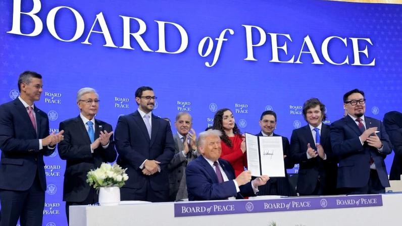 U.S. President Donald Trump (seated) holds up his signature on the founding charter during a signing ceremony for the “Board of Peace” at the World Economic Forum in Davos, Switzerland, on Jan. 22.