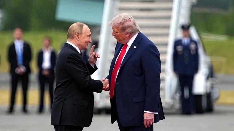 U.S. President Donald Trump shakes hands with Russian President Vladimir Putin.