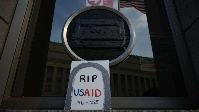 Tributes are shown beneath the covered seal of the U.S. Agency for International Development at its headquarters in Washington, D.C., on Feb. 7, 2025.