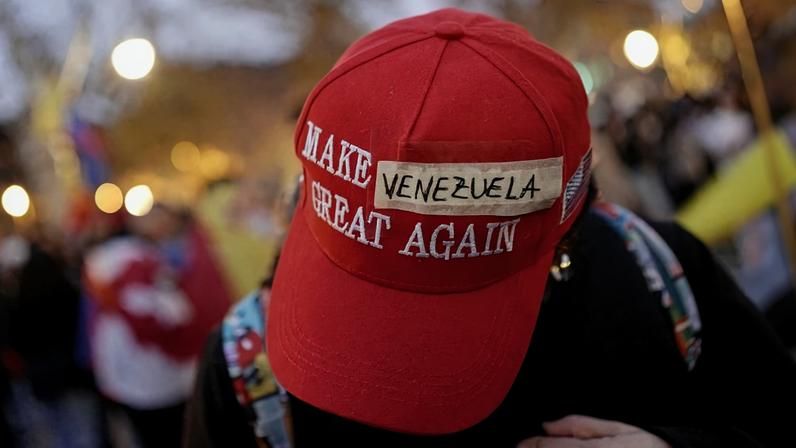 A protester wears a modified "Make America Great Again" hat with "Venezuela" taped over the original text during a demonstration in Barcelona, Spain, on Jan. 4.