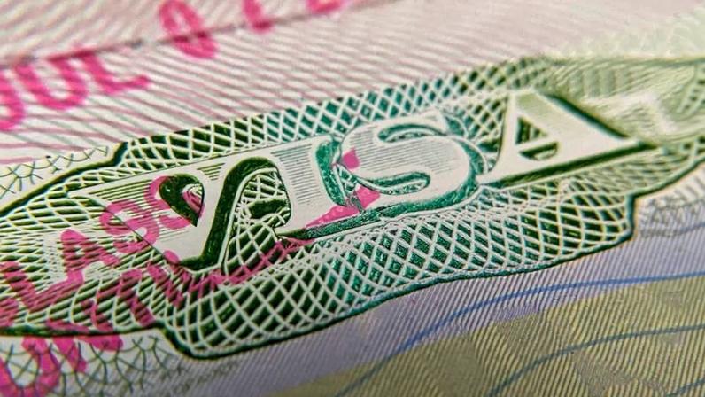 This photo illustration shows a visa stamp on a foreign passport in Los Angeles on June 6, 2020.