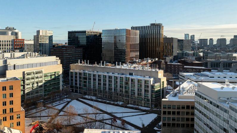 Aerial view of the MIT campus in winter, with Kendall Square in the background