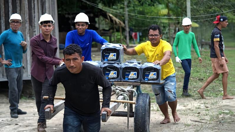 Community members take part in the installation of solar panels in the Porto Rico community, in the Brazilian Amazon.