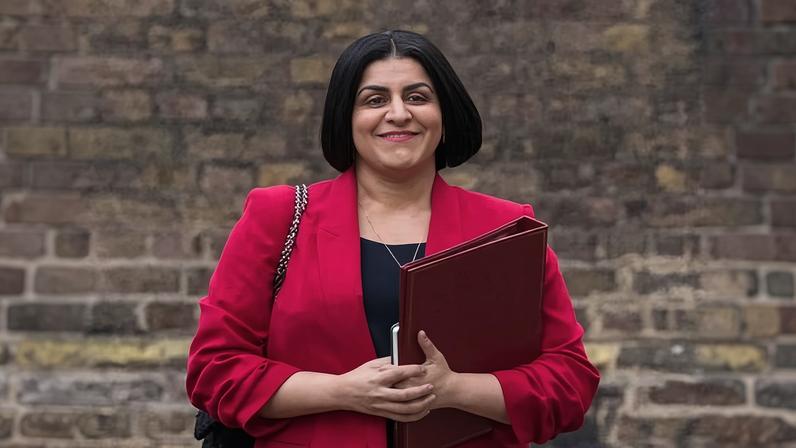 Mahmood holding ministerial folder