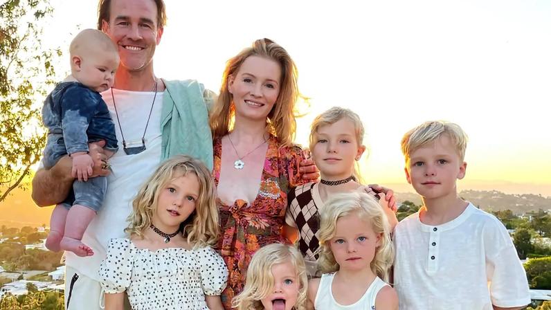 James Van Der Beek, his wife Kimberly, and their six children posing together outdoors.