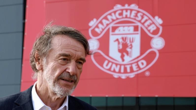 Jim Ratcliffe pictured in front of a Manchester United badge outside Old Trafford in 2023